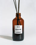 L:A BRUKET No 322 Beach Fire room diffuser in amber glass with reeds