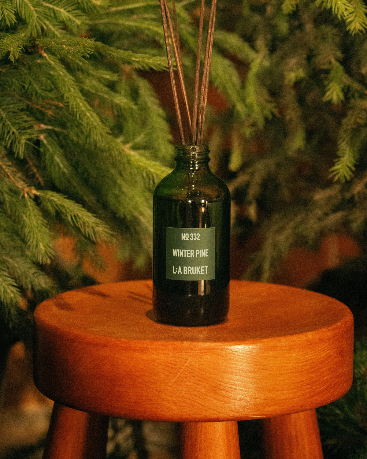 L:A BRUKET Winter Pine room diffuser styled in a winter setting