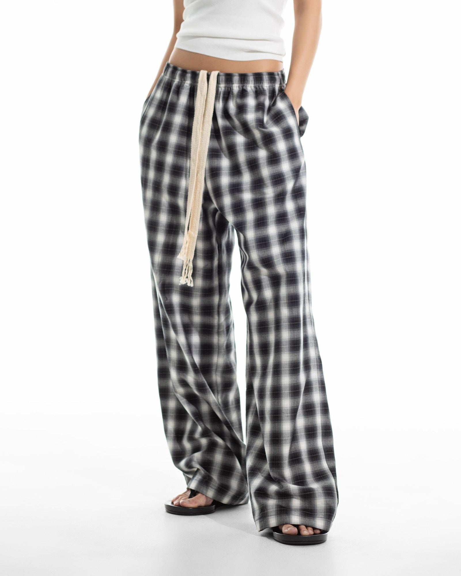 Oversized plaid check wide pants shown in motion — relaxed drape through the leg